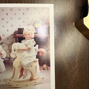 Source Unknown Porcelain Doll on Cream Rocking Horse
